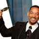 Actor Will Smith holds up his Oscar at the 2022 Academy Awards.